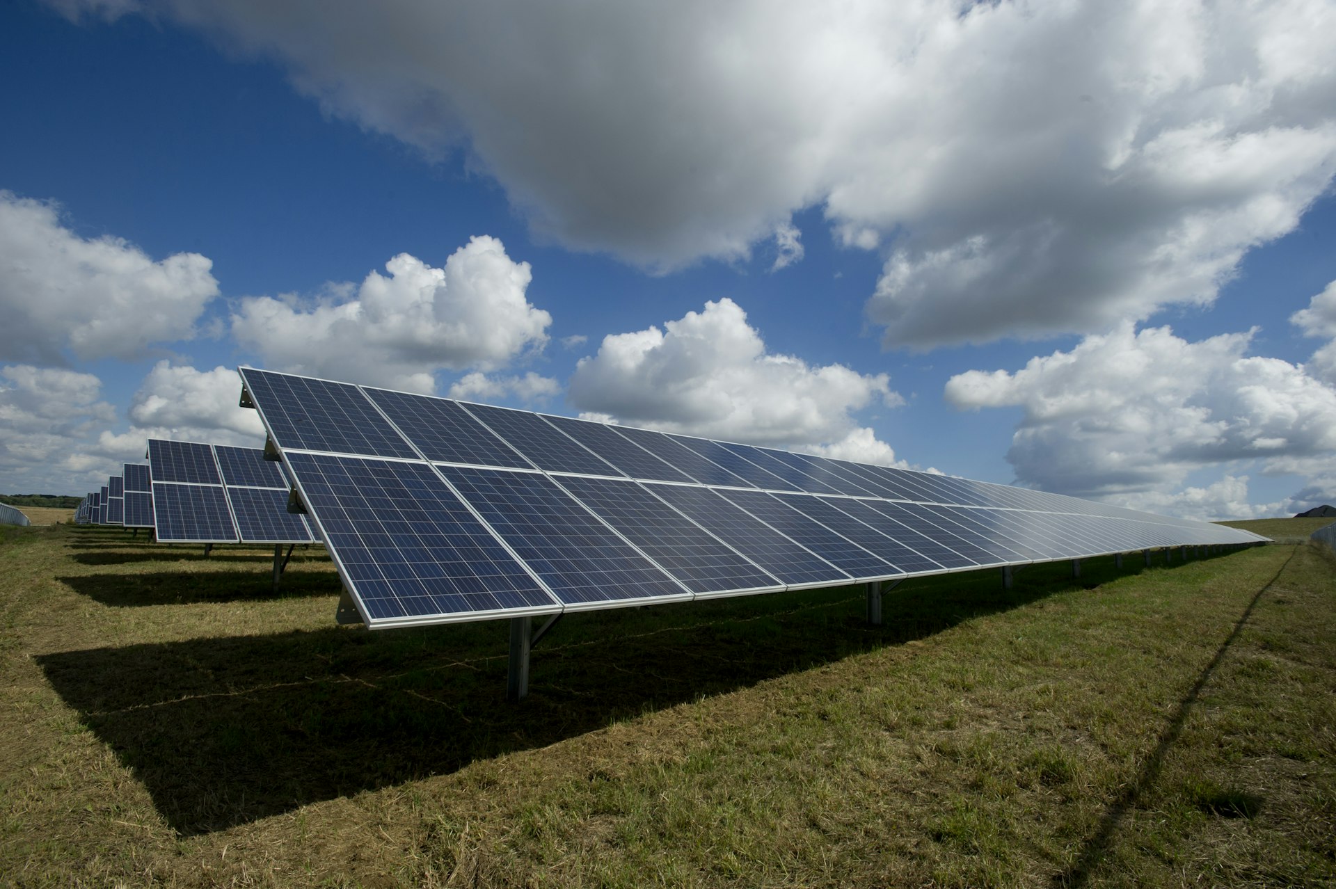 Solar panels at sunrise in front of Spanish mountains